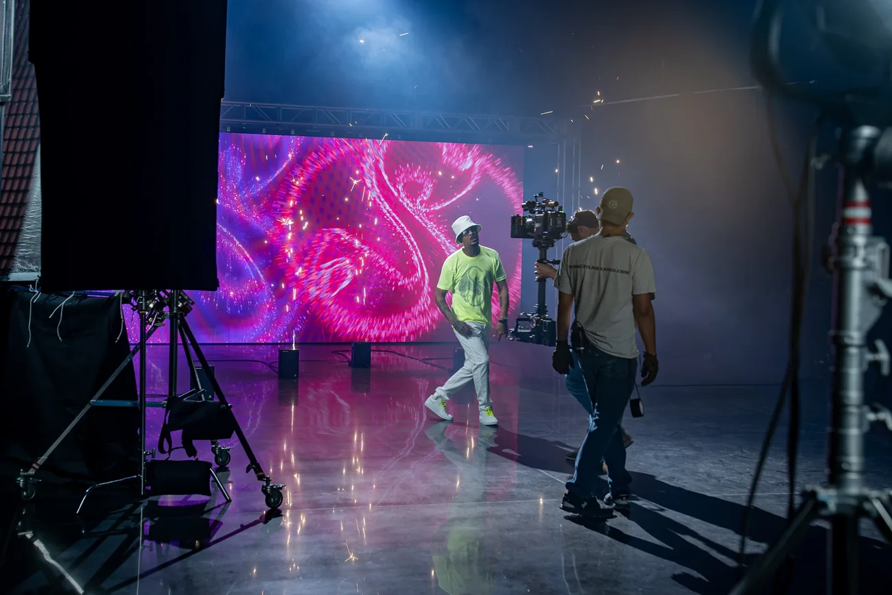 A crew shooting against a custom backdrop