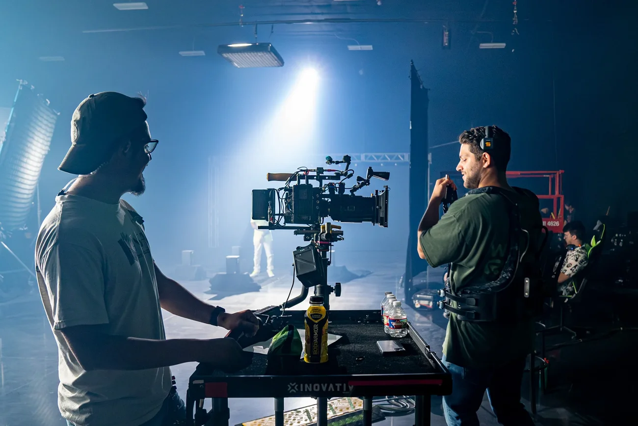 Camera operator working a lit setup